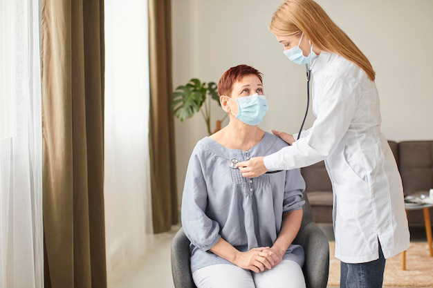 elder-patient-with-medical-mask-being-checked-by-covid-recovery-center-female-doctor_23-2148847860