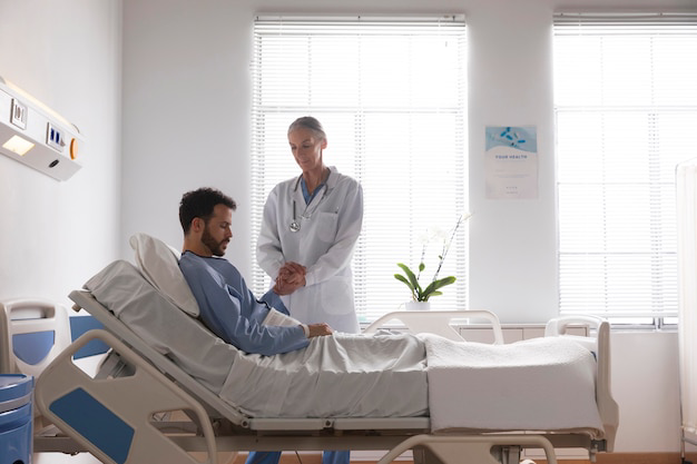 ill-male-patient-bed-talking-nurse_23-2148981216